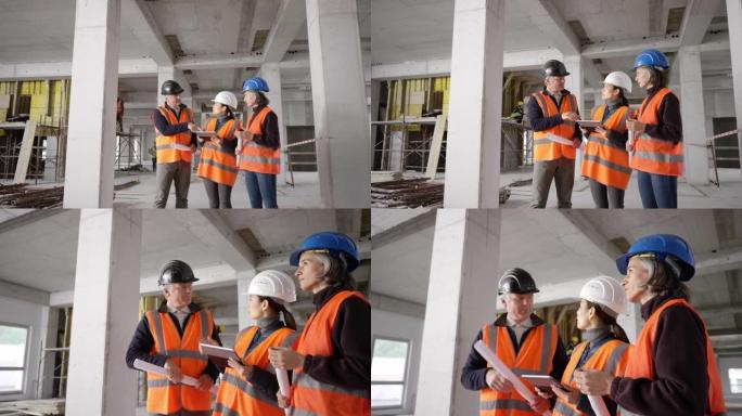 男建筑工程师在施工现场与女建筑师和一名女服务员交谈