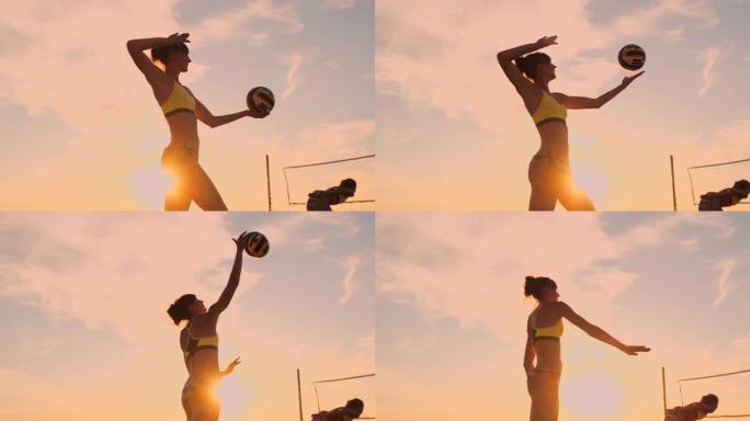 沙滩排球发球-女子在沙滩排球比赛中发球。上手扣球发球。年轻人在阳光下玩得开心，在户外健康积极的运动生