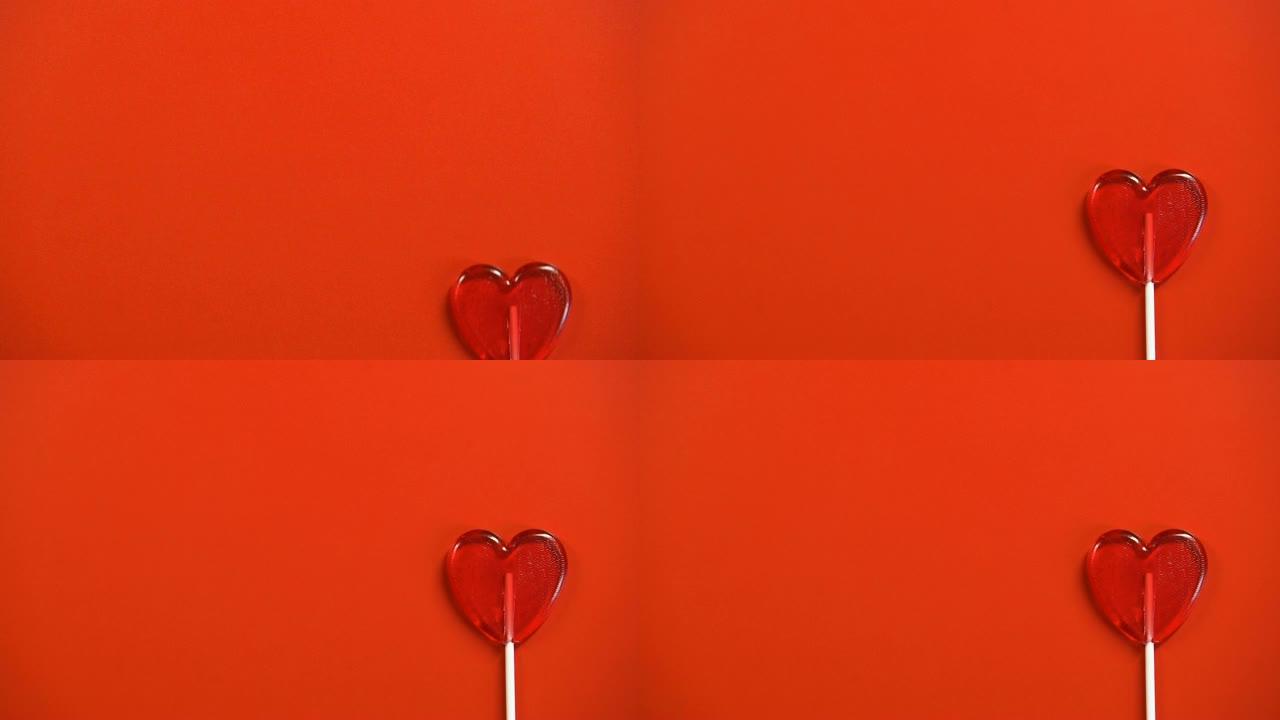心形棒棒糖隔离在红色背景上，情人节庆祝活动