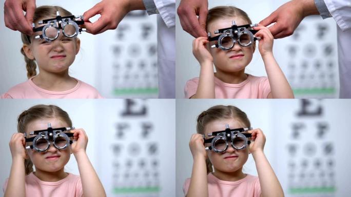 医生在儿童上佩戴光学试验架以诊断近视，视力模糊
