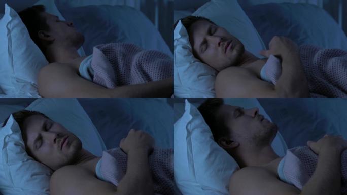 年轻男性有焦虑的梦想，在长时间紧张的工作日后在睡眠中交谈