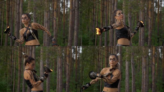 森林中的女人正在与火碗共舞