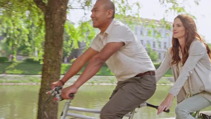 男人和女人在城市公园骑双人自行车