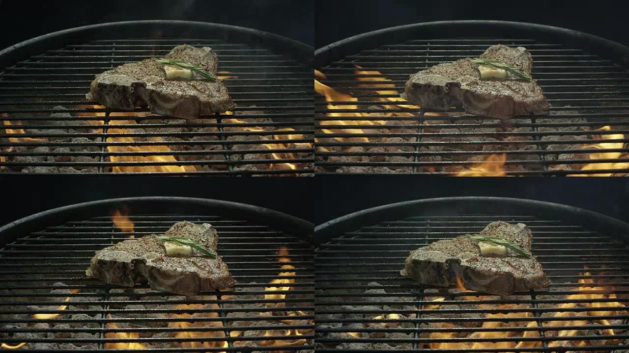 调味的T骨牛排加黄油和迷迭香在烧烤架上的煤上煮