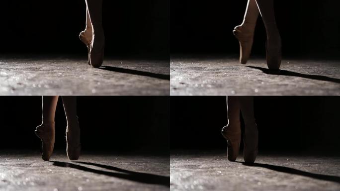 穿着脚尖鞋的女性腿。芭蕾舞练习。芭蕾舞者美丽纤细优美的双腿。特写。