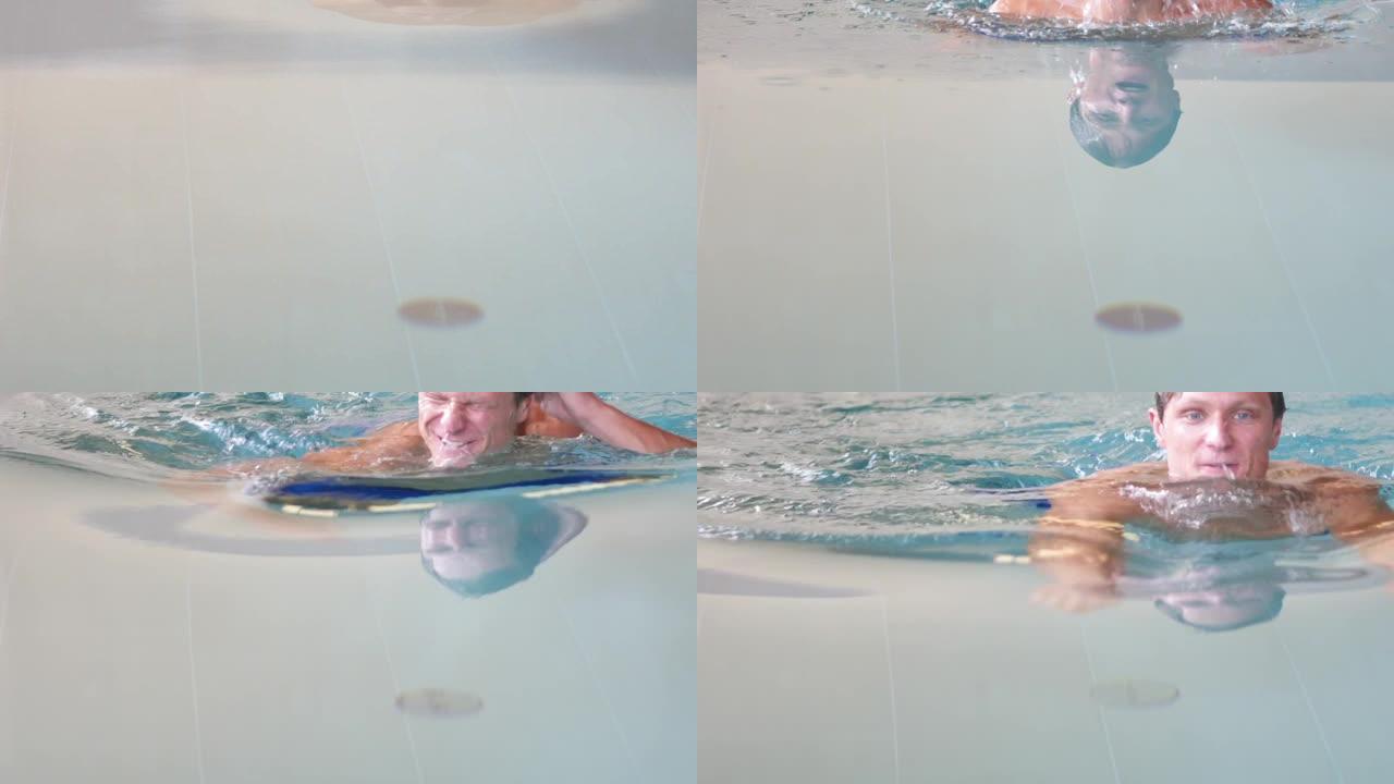 一个男人在游泳池里朝摄像机游泳的特写镜头