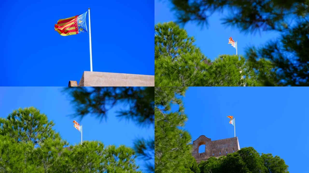 瓦伦西亚 (西班牙) 的旗帜在蓝天下飞过建筑物