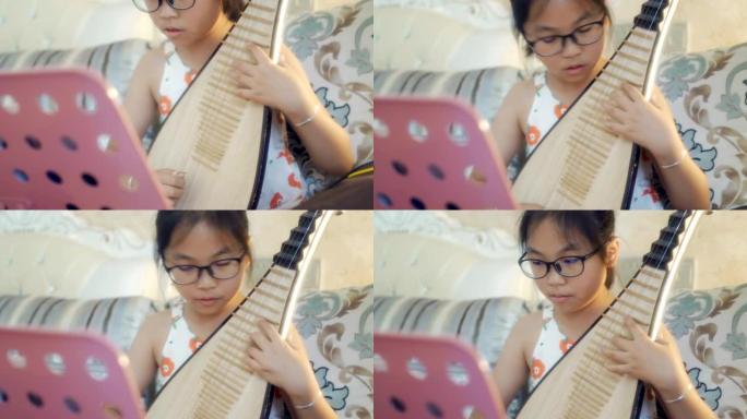 小女孩演奏中国琵琶 (琵琶)