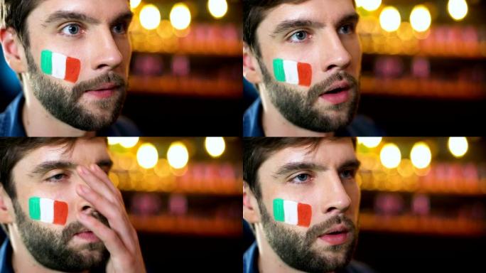 紧张的大胡子男球迷，脸颊上有意大利国旗，使面部表情，球队输了