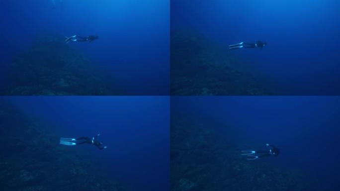 潜水潜水员在海洋深处游泳的水下视图