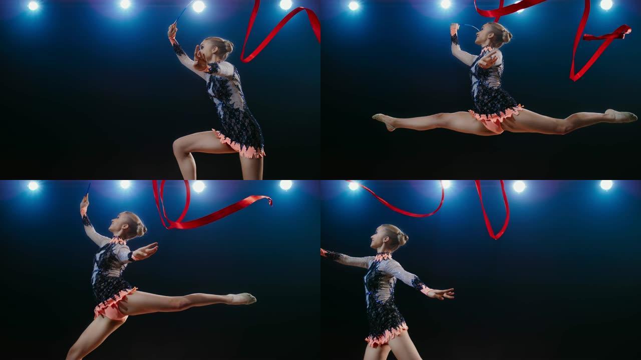 SLO MO艺术体操运动员的红丝带在空中旋转，进行了一次跳跃
