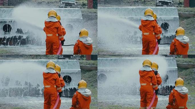 慢动作: 消防员用泡沫喷雾扑灭大火