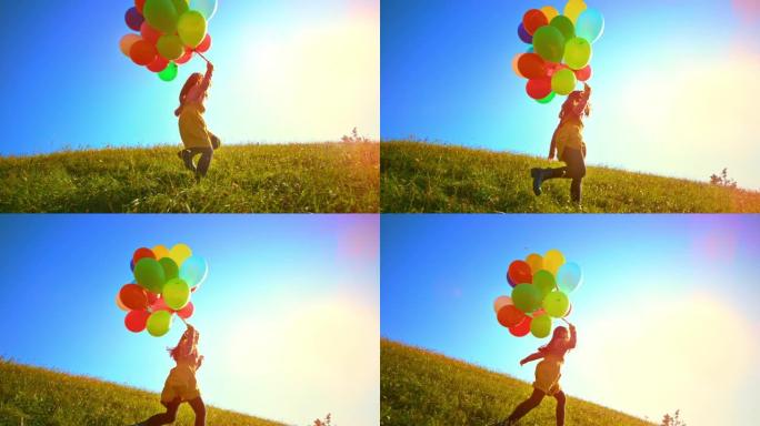 SLO MO女孩带着一堆五颜六色的气球在阳光明媚的草地上奔跑