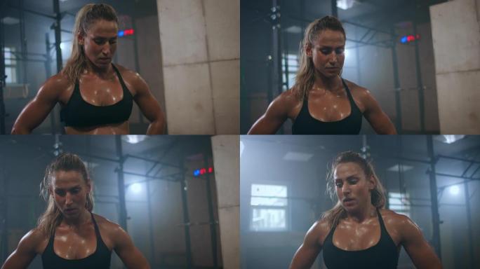 疲惫，精疲力竭的女人在训练后呼吸沉重，汗水滴落。力量的形成和运动前的集中。锻炼交叉训练。