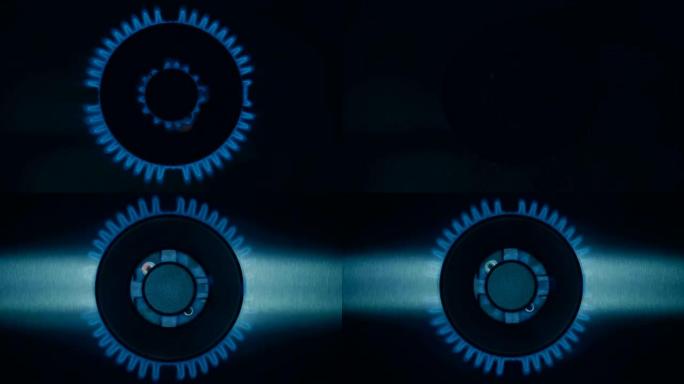 燃气灶燃烧器在黑暗中以蓝色火焰点燃