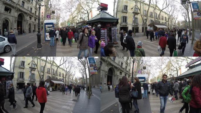 人们走在西班牙巴塞罗那市中心拥挤的La Rambla街