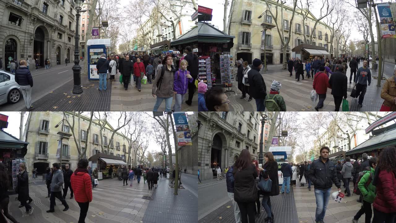 人们走在西班牙巴塞罗那市中心拥挤的La Rambla街
