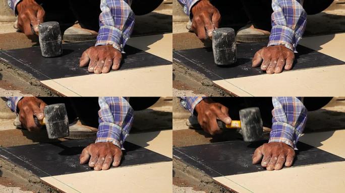 慢动作，建筑工人使用锤子瓷砖地板