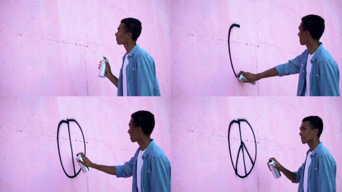 害怕的少年用喷漆在墙上画和平符号，停止种族主义