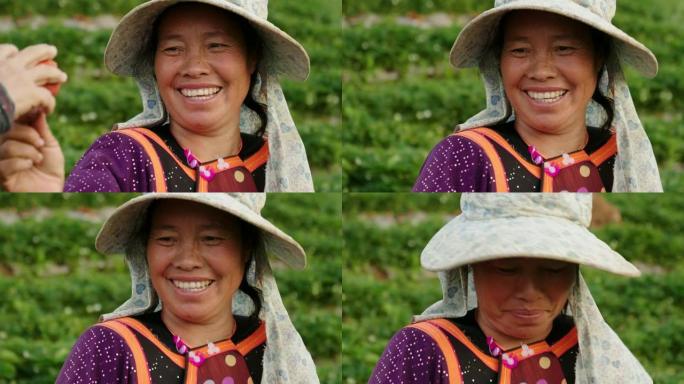 微笑的女农民在农场采摘草莓