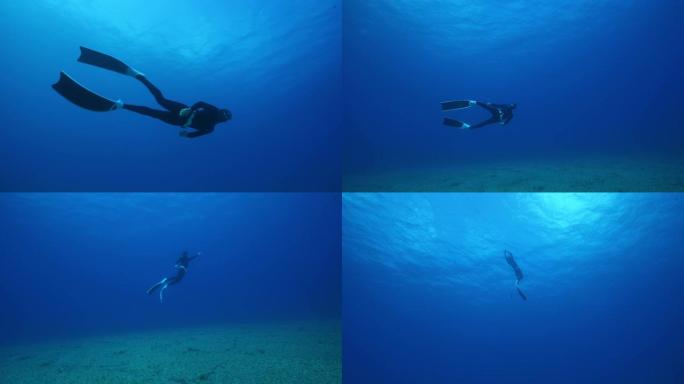 水肺潜水员向海底潜水然后重铺的水下视图