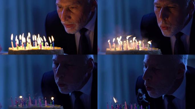 开朗的老人吹着蛋糕蜡烛庆祝生日，幸福