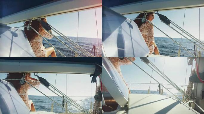 女人在游弋大海的游艇上晒日光浴