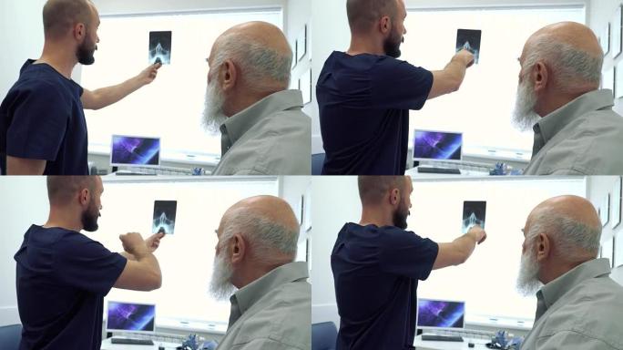 风湿病学家向一个成熟的男人展示射线照片