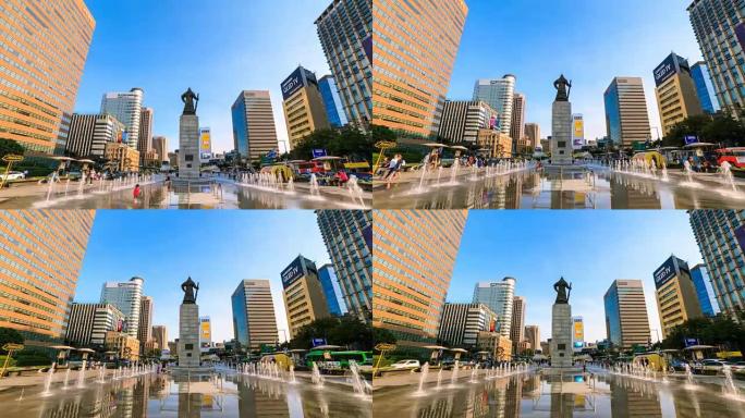在韩国首尔市中心的光化门广场上，美丽的彩色喷泉和办公楼的4k时间流逝与李舜臣海军上将的雕像。