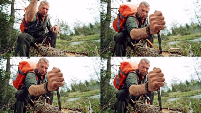 SLO MO男性荒野生存专家将刀插入树干