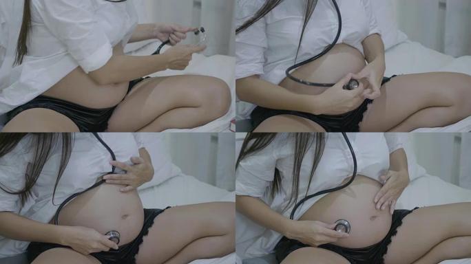 孕妇通过听诊器听婴儿的心跳