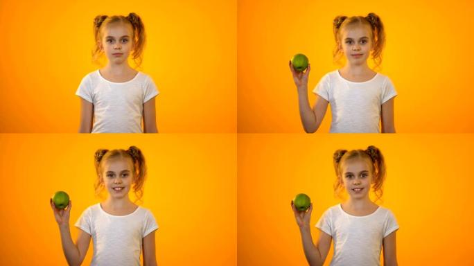 可爱的少女展示新鲜的绿苹果，健康营养，有机食品