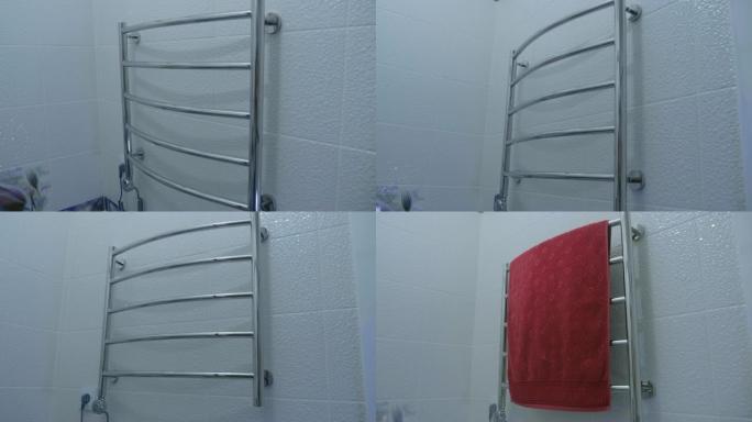 浴室内部: 带毛巾的镀铬壁挂式电动毛巾取暖器