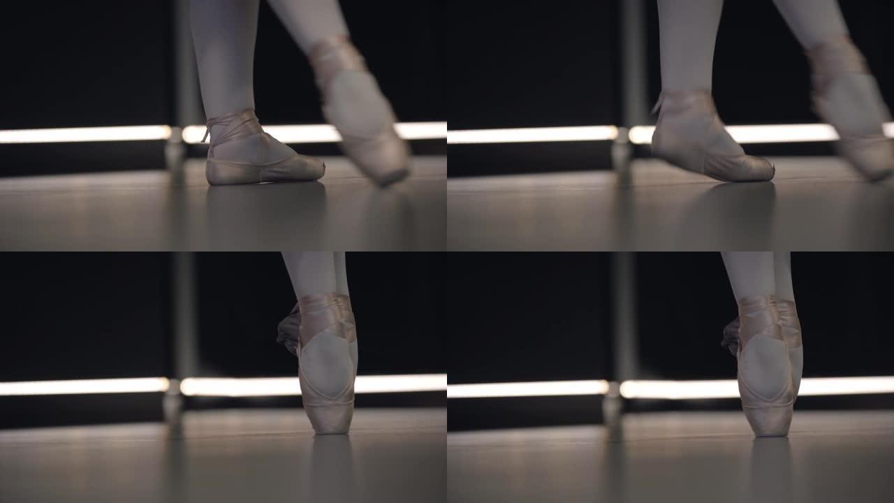 优雅的芭蕾舞演员双脚并拢，tip起脚尖。芭蕾舞演员脚尖的特写镜头。优雅，艺术，优雅，舞蹈。