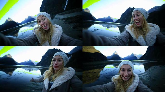 女人在新西兰米尔福德峡湾拍摄自拍照