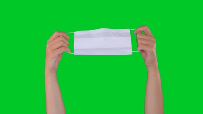 双手在色度键绿色屏幕上显示保护性面罩