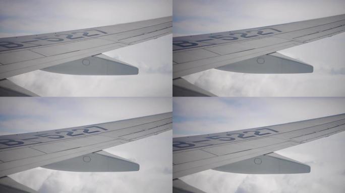从窗户看飞机机翼和天空