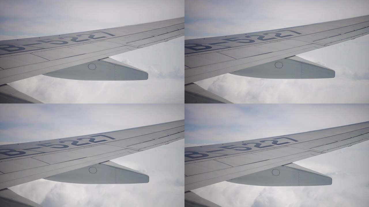 从窗户看飞机机翼和天空