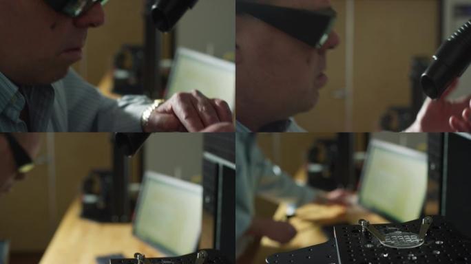 四十多岁的高加索工程师戴着护眼装置，在室内制造工厂的激光加工超快系统上切开了一块蓝宝石圆盘