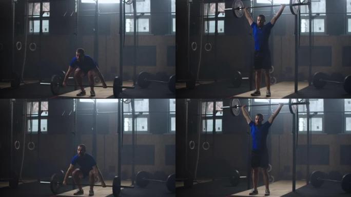 强壮的人在健身房做慢动作的杠铃抓举运动