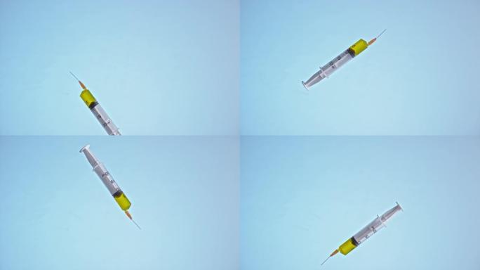 黄色液体在蓝色背景下在空中飞行的SLO MO LD注射器