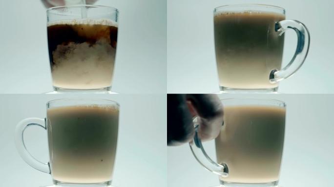 热黑咖啡与奶瓶中的牛奶一起倒，手喝一杯