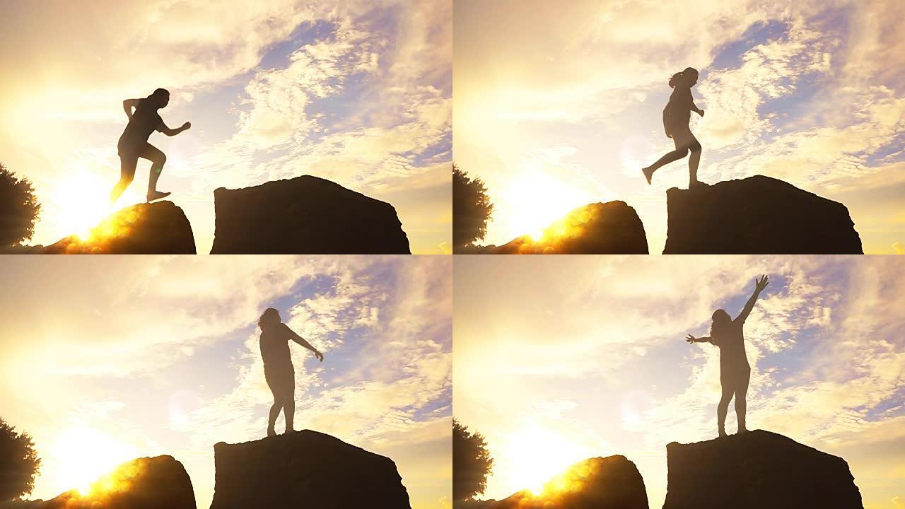 女人从岩石上跳到山顶的慢动作，自由概念
