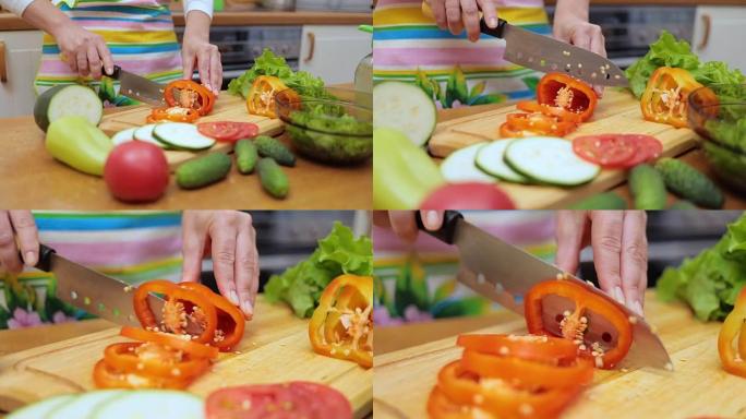 家庭主妇的女手用刀在砧板厨房桌子上切新鲜的甜椒
