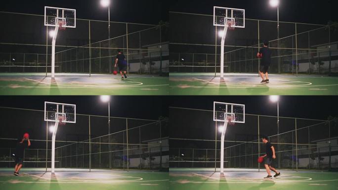 一个人晚上独自在室外球场打篮球。