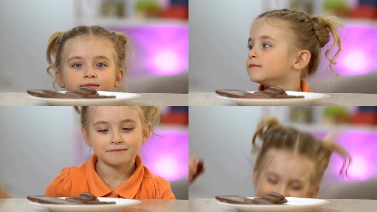 女孩从桌子底下出现，偷一块巧克力棒，甜食