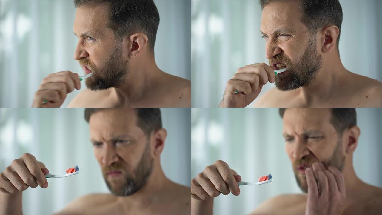 男性在浴室看血牙刷，口腔卫生，牙病病