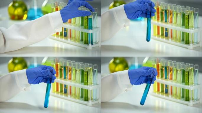 实验室助理用蓝色液体检查管子中的沉淀物，洗涤物质