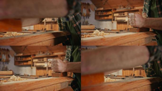 男性木匠用飞机塑造一块木头的SLO MO手