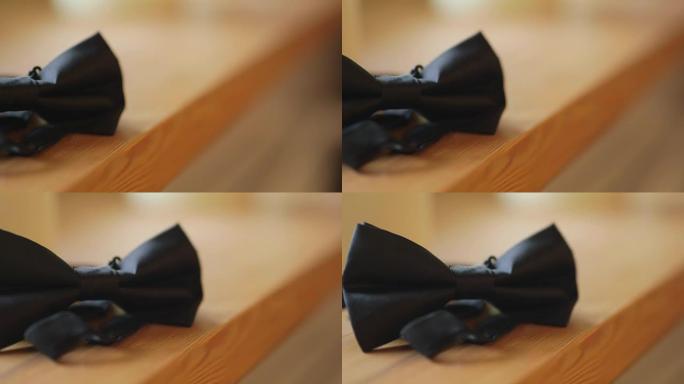 木制桌子上黑色领结的特写
